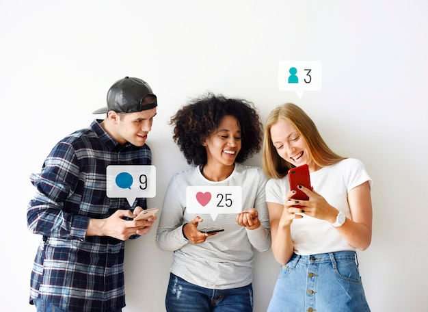 Happy friends looking at social media on a smartphone