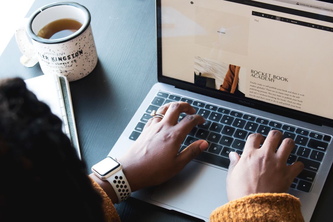 Free A Person Typing on a Laptop Stock Photo