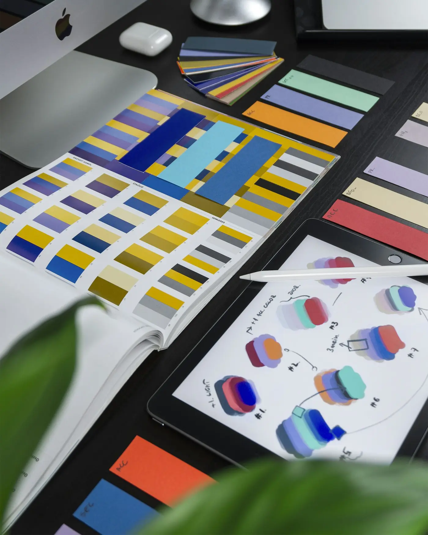 Color swatches and interface design sketches on a desk