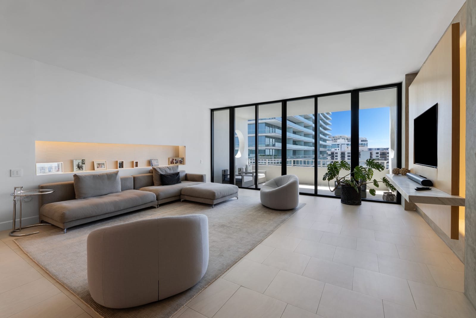 A modern Miami condominium living room with floor-to-ceiling glass