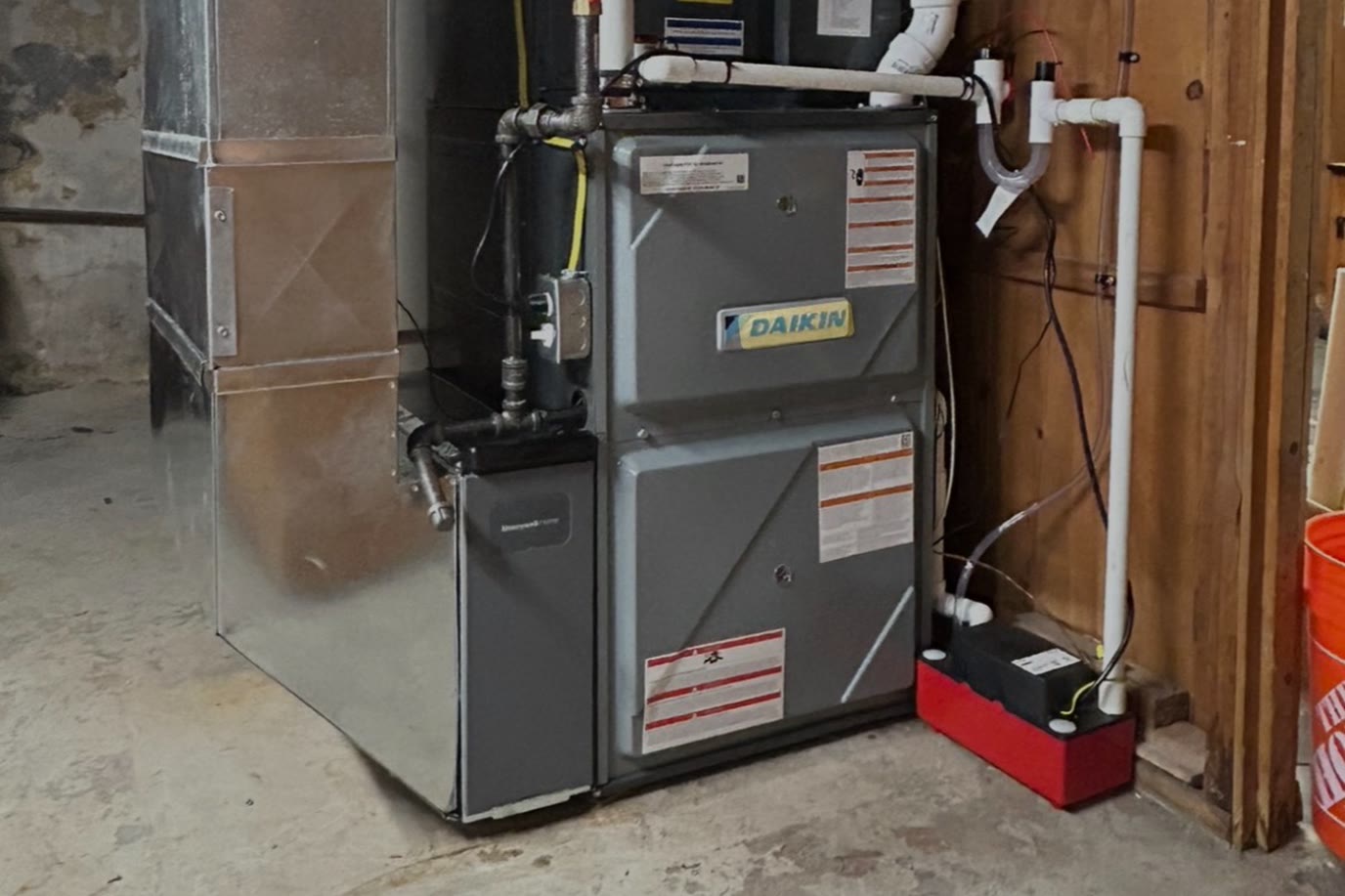 High-efficiency Daikin gas furnace installed in a basement utility room