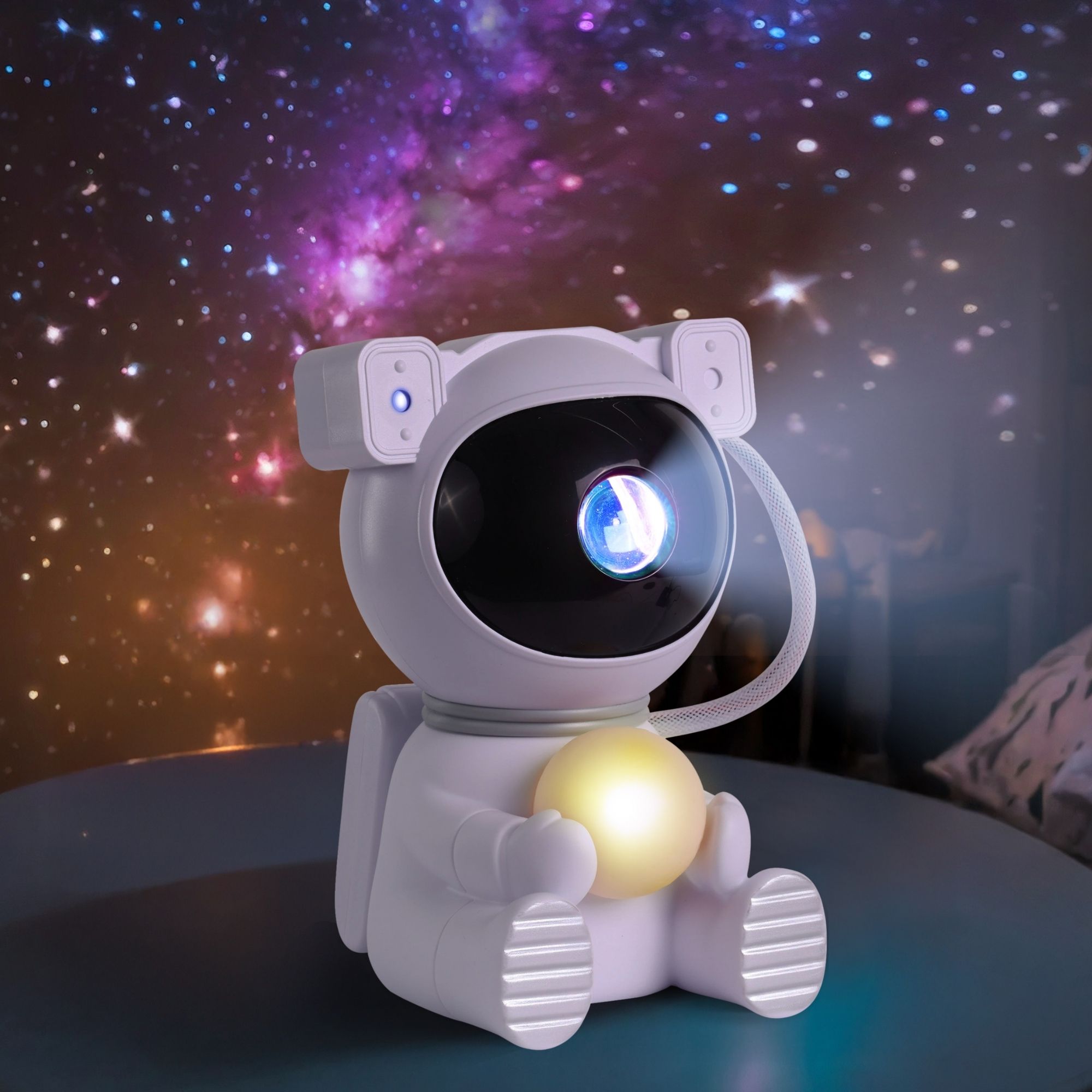 Astronaut galaxy projector filling a bedroom ceiling with stars