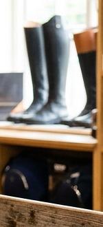 Tall leather English field boots on a shop shelf