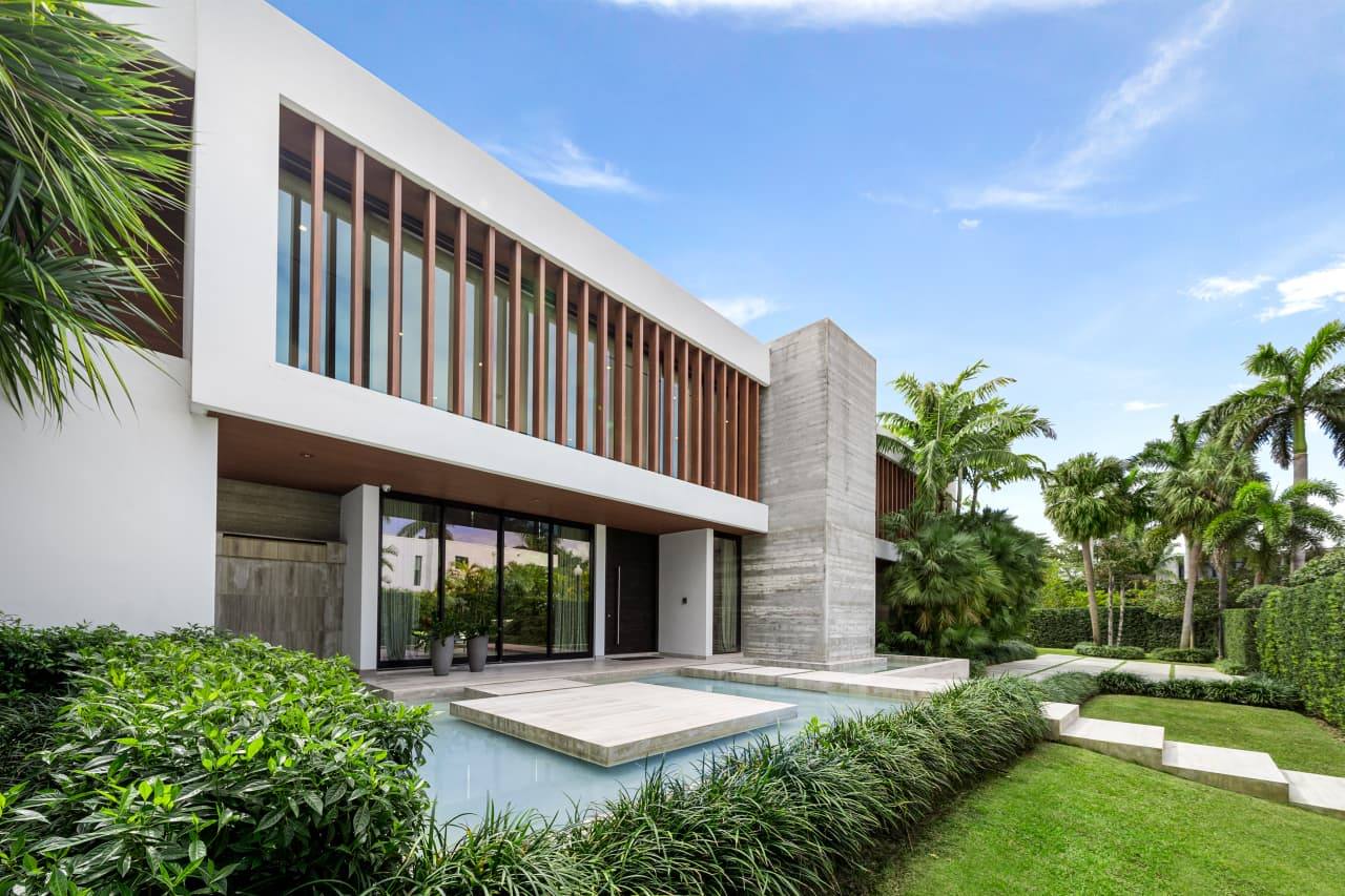 A modern single-family estate with a pool and mature landscaping
