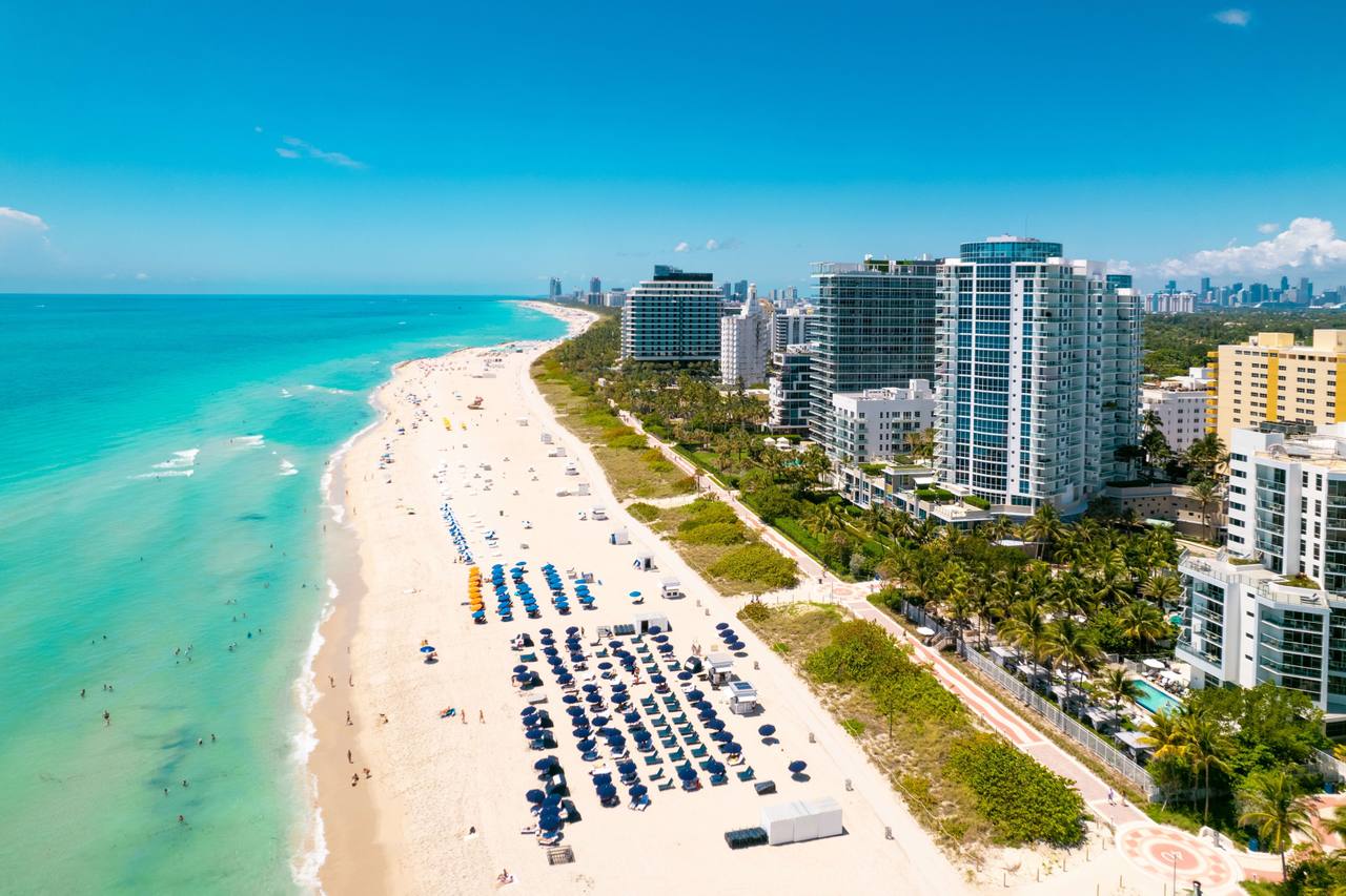 Aerial view of the beach and low-rise oceanfront buildings