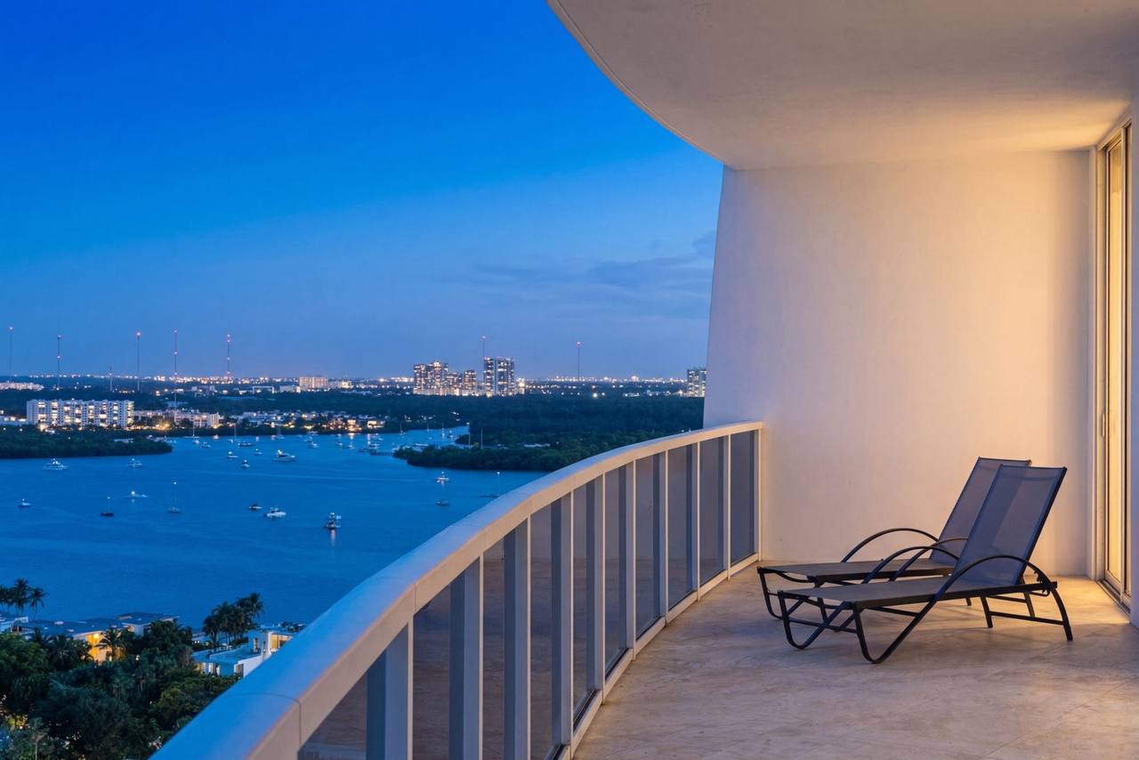 A condominium balcony at twilight overlooking Biscayne Bay and the Miami skyline