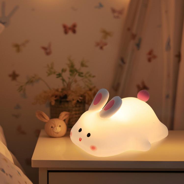 Kawaii silicone bunny night light on a nightstand