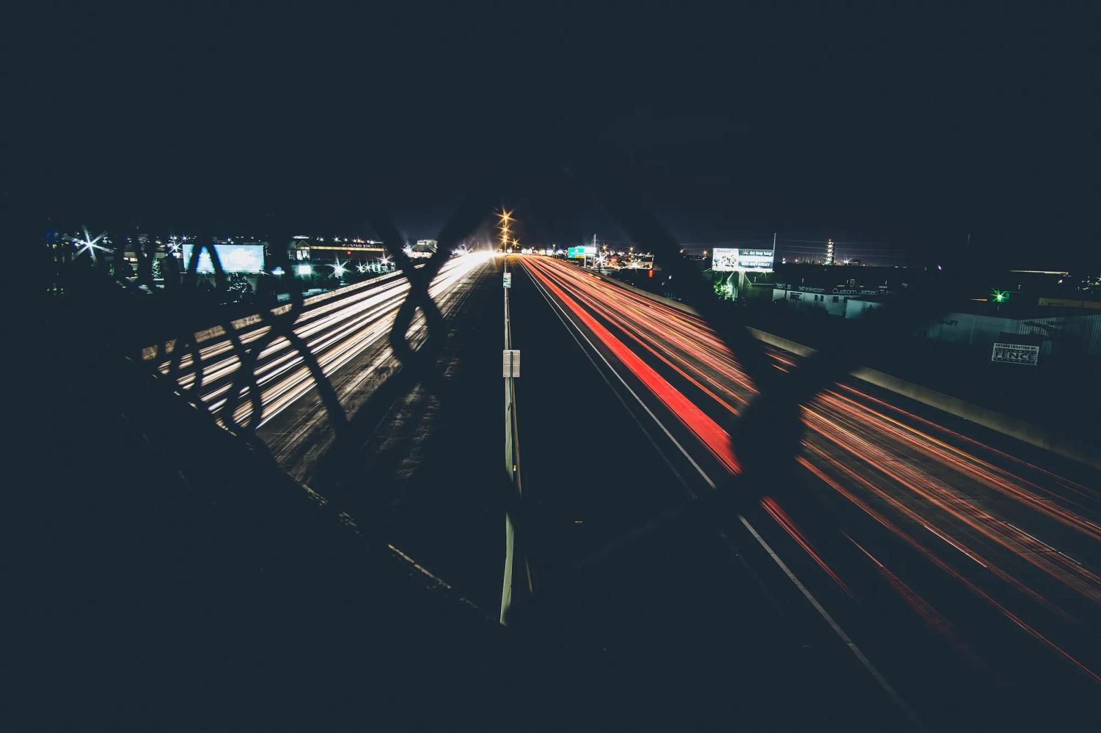 Light trails from traffic on a divided highway at night