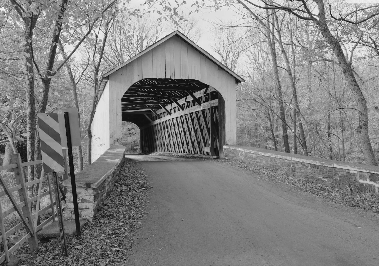 A covered bridge on a wooded Bucks County road