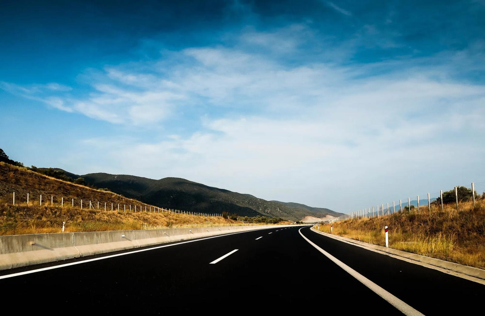 An open highway under a blue sky