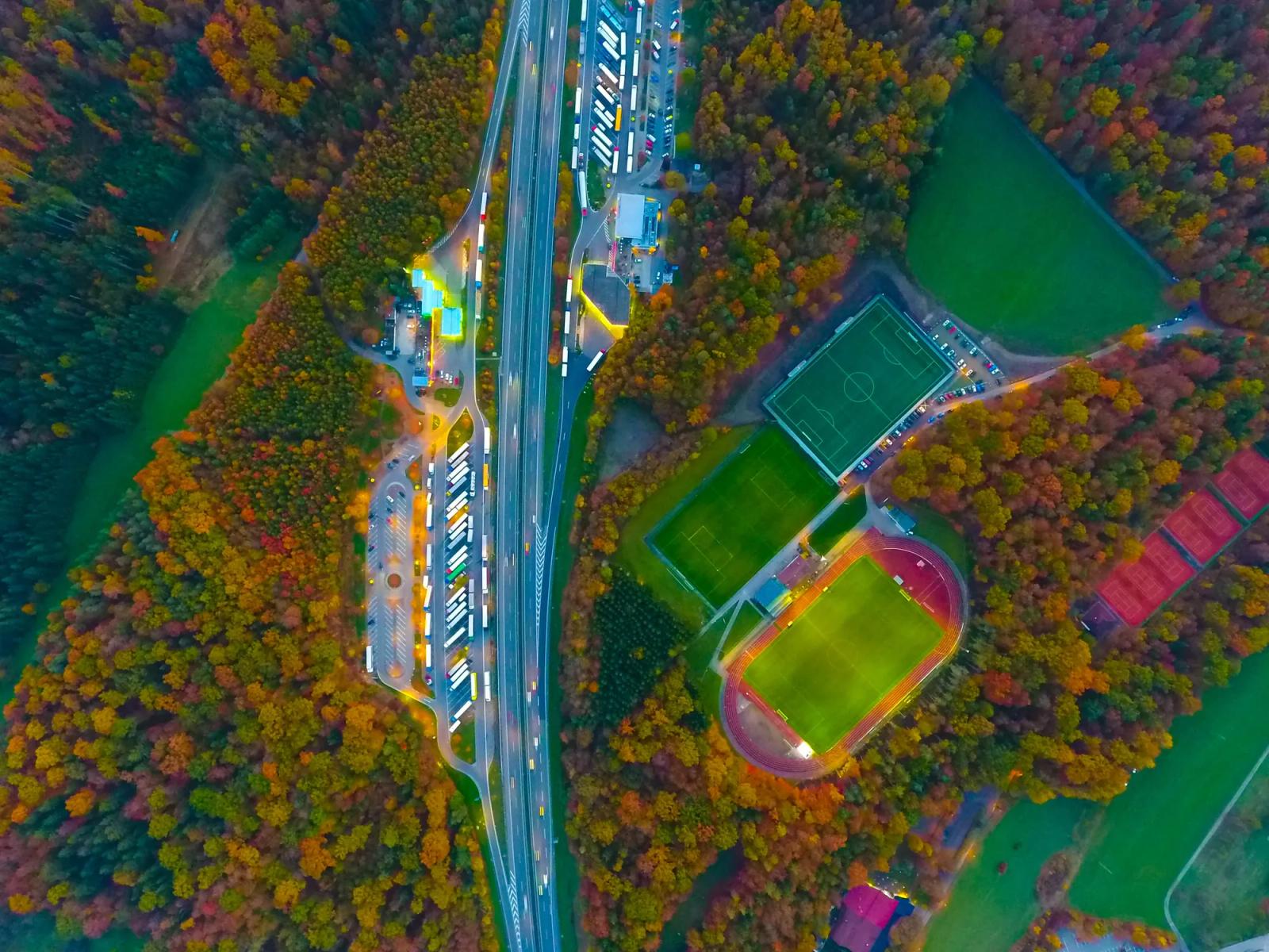 Aerial view of a highway through autumn trees